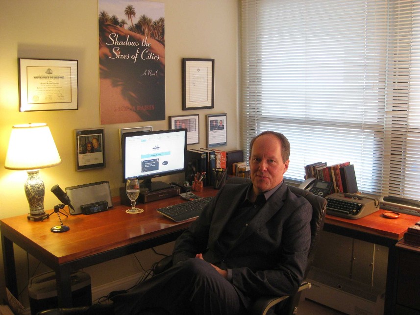 Gregory W Beaubien, Editor in Chief of Moresby Press, sits at his desk