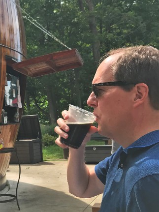 Greg Beaubien drinks a cold root beer outdoors in Michigan